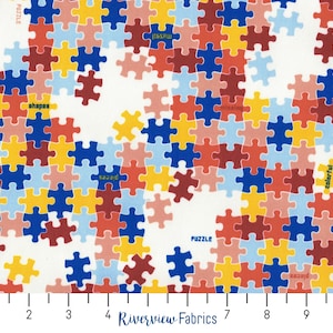 May include: A white fabric with a repeating pattern of colorful jigsaw puzzle pieces. The pieces are in shades of red, blue, yellow, and pink. The words "puzzle", "shapes", "pieces", "jigsaw", and "colorful" are written on some of the pieces.