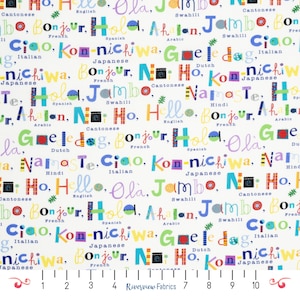 May include: White fabric with colorful text in various languages, including "Hello," "Bonjour," and "Hola." The words are in different fonts and colors, creating a playful and diverse pattern. A ruler is at the bottom.