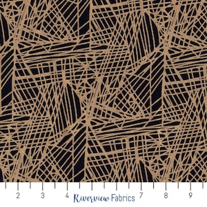 Puede incluir: Tela negra con un patrón geométrico dorado de líneas superpuestas. La tela se mide con una regla en pulgadas.