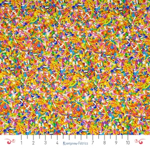 May include: A vibrant fabric covered in a dense pattern of colorful sprinkles. The sprinkles are a mix of shapes and sizes, including rods and stars, in shades of yellow, orange, pink, blue, green, and purple. The fabric has a playful and festive appearance.