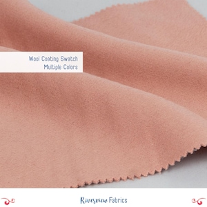 May include: Close-up of a swatch of wool coating fabric in a soft, muted peach color. The fabric is folded, showing its texture and the cut edge. Text on the image reads "Wool Coating Swatch Multiple Colors". The Riverview Fabrics logo is at the bottom.