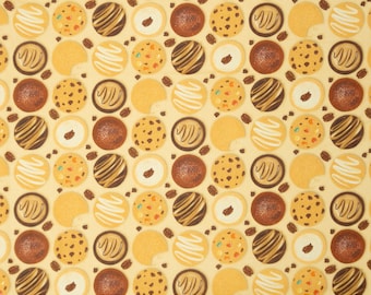 May include: A yellow fabric with a repeating pattern of various cookies. The cookies are in different shapes and colors, including chocolate, vanilla, and gingerbread.