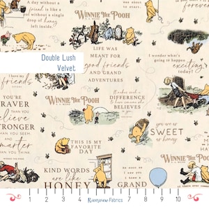 May include: Cream fabric with illustrations of Winnie the Pooh characters and quotes. The design includes images of Pooh Bear, Piglet, and other characters, along with text elements and the words "Double Lush Velvet".