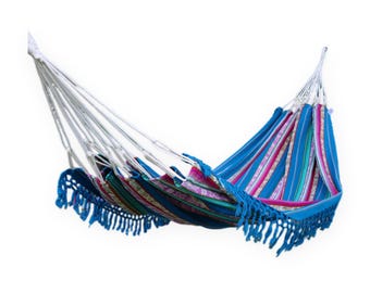 May include: A fabric hammock featuring a vibrant striped pattern in shades of blue, pink, and white. The hammock includes white suspension ropes at both ends and decorative blue fringe trim along the bottom edge of the fabric body.