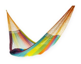 May include: A woven hammock featuring a vibrant rainbow color gradient pattern. The design consists of thin, interlaced strings forming a net structure with alternating stripes of yellow, orange, red, purple, blue, and green hues throughout.