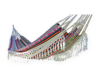 May include: A woven hammock featuring a cream-colored base with horizontal stripes in shades of pink, orange, yellow, blue, and green. The fabric is accented with decorative floral embroidery and finished with long white fringe along the edge.