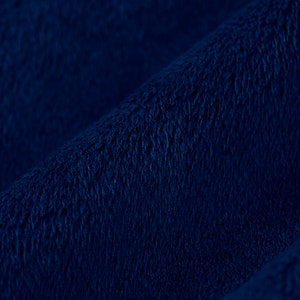 May include: Close-up of a deep blue plush fabric with a soft, fuzzy texture.