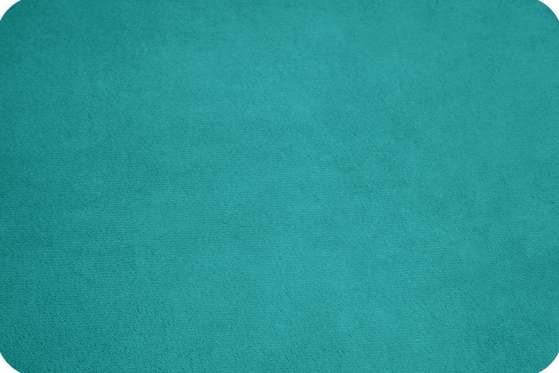 May include: A solid teal blue fabric swatch. The fabric has a soft, fuzzy texture.
