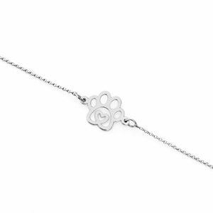 May include: A silver chain bracelet with a paw print charm featuring a heart inside. The charm is a delicate cutout design.