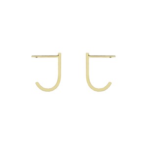 May include: A pair of gold-toned hoop earrings with a simple, minimalist design. The earrings are shaped like a 'J' and are made of a thin, delicate metal.