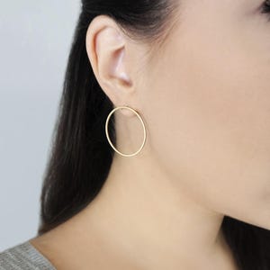 May include: A pair of gold hoop earrings. The earrings are simple and elegant, and they would be a great addition to any jewelry collection.
