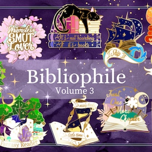 May include: A set of 10 enamel pins featuring book-themed designs. The pins are gold-toned with colorful enamel accents. The designs include a cat sleeping on books, a ship with a book as a sail, a heart with a heartbeat line and books, a book with a door, a book with a clock, a book with a moon and a sheep, a book with a hand reaching out, a book with a tree and a crystal, a book with a clock and the words "So much to read", and a book with the words "Shameless Smut Lover".