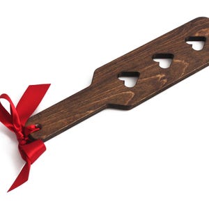 wooden spanking paddle with hearts cut out