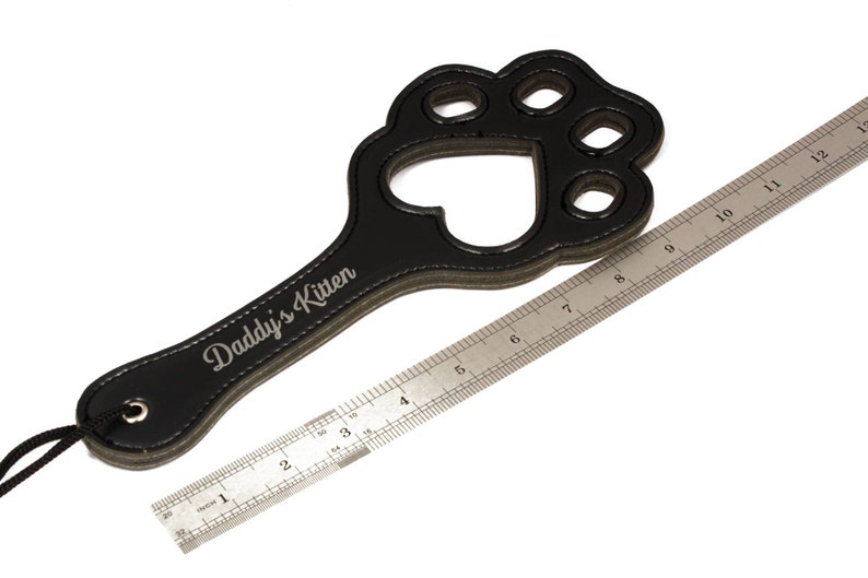 Paw paddle against ruler to show dimensions
