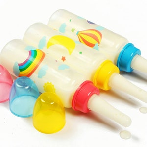 Custom adult baby bottles. Long, fast flow teat on 240ml abdl bottle. Adorable rainbow, moon and hot air balloon. Ideal for ddlg/littlespace