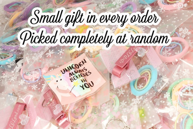 May include: A variety of small gifts in clear plastic bags, including hair ties, keychains, and a card with a unicorn design that says "Unicorn Always Believes in You".