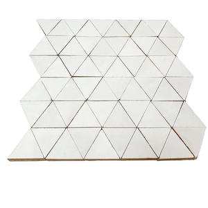 May include: White ceramic tile mosaic with a geometric pattern of triangles. The tiles are arranged in a staggered pattern, creating a visually interesting design.