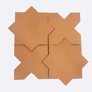 May include: Four terracotta tiles with a geometric star pattern. The tiles are arranged in a square shape.