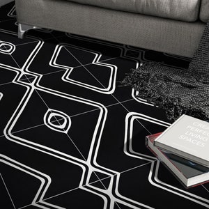 May include: Black and white geometric patterned floor tiles with white lines forming a diamond pattern. The tiles are arranged in a repeating pattern.
