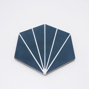 May include: A blue hexagonal tile with a white sunburst design. The tile has a matte finish and is perfect for adding a modern touch to any space.