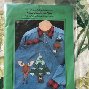 May include: A green and white pattern sheet for a machine applique patchwork project called "Forest Friends". The pattern includes three dimensional animals and trees. The pattern number is #7.