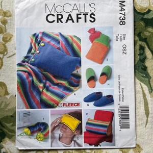 May include: A sewing pattern for making various fleece items, including a blanket, eye mask, slippers, and a hot water bottle cover. The pattern is from McCall's Crafts and is labeled M4738. The pattern includes instructions for making the items from "Fabulous Fleece."