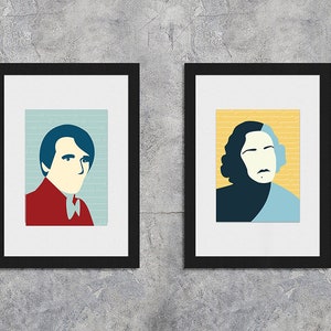 May include: Two framed portraits of people, one with a blue, red, and white color scheme and the other with a blue, yellow, and white color scheme.