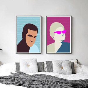 May include: Two framed illustrations of people's faces. The illustration on the left is of a person with brown skin and short black hair. The illustration on the right is of a person with light skin and short blonde hair wearing pink sunglasses. Both illustrations have a blue background with white text.