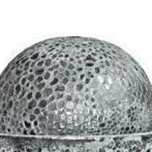 May include: A decorative, silver-colored bowl with a matching, textured, spherical top. The bowl and sphere have a porous, mosaic-like design, creating a unique, artistic appearance. The bowl is wide and shallow, while the sphere sits atop it.
