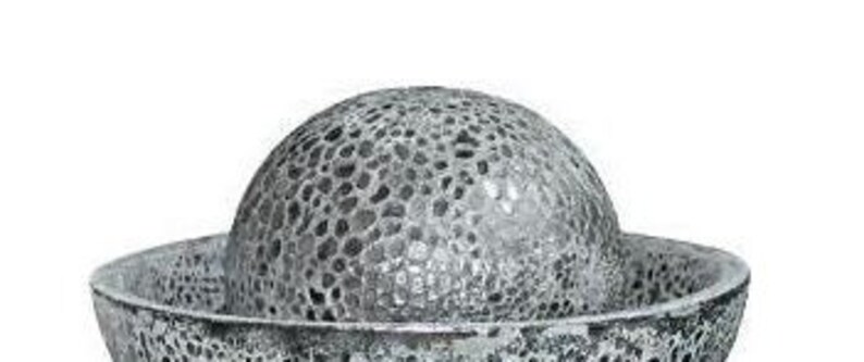 May include: A decorative, silver-colored bowl with a matching, textured, spherical top. The bowl and sphere have a porous, mosaic-like design, creating a unique, artistic appearance. The bowl is wide and shallow, while the sphere sits atop it.