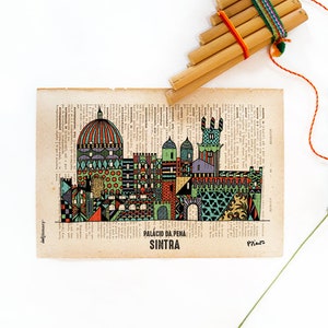 May include: A colorful illustration of the Palacio da Pena in Sintra, Portugal, printed on a vintage book page. The illustration is in a geometric style and features a variety of colors, including green, blue, red, and yellow.