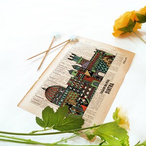 May include: A vintage book page with a colorful illustration of the Palacio da Pena in Sintra, Portugal. The illustration is surrounded by text in Portuguese.