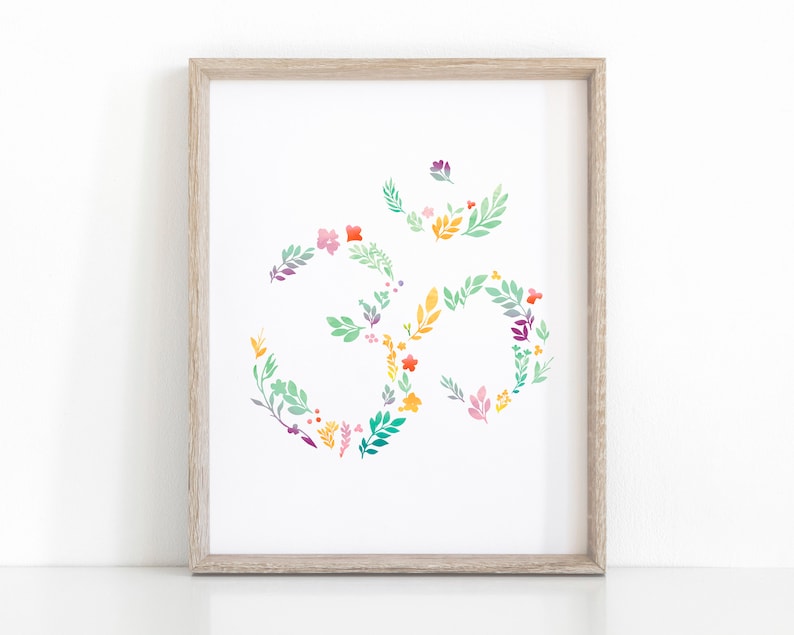May include: A framed print of a floral Om symbol in shades of green, yellow, pink, and purple. The Om symbol is a spiritual symbol in Hinduism and Buddhism.