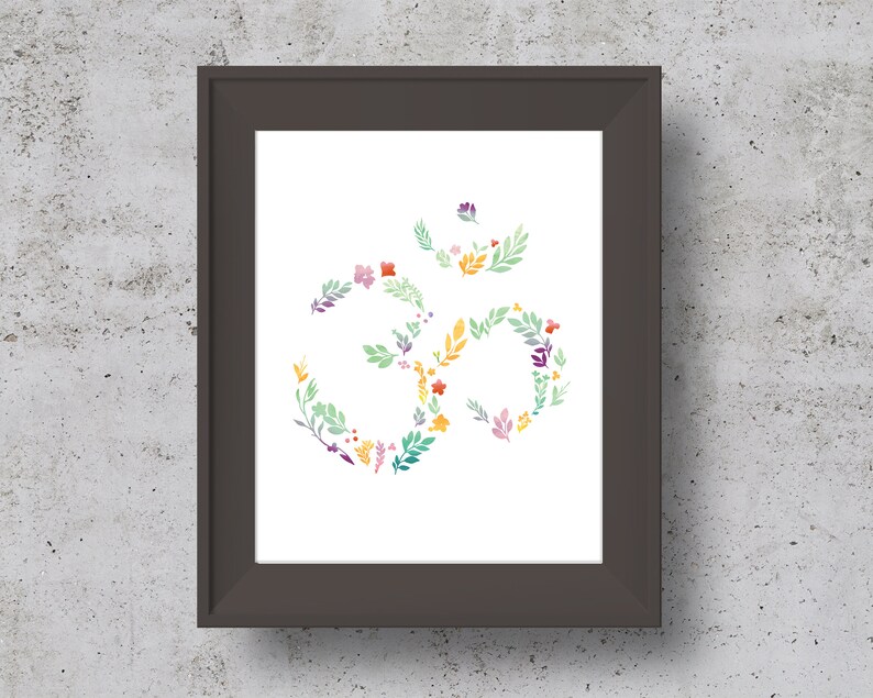 May include: A framed print of a floral Om symbol in shades of green, yellow, pink, and purple. The Om symbol is made up of stylized flowers and leaves.