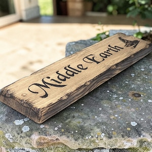 Close angle view of engraved rustic oak house sign
