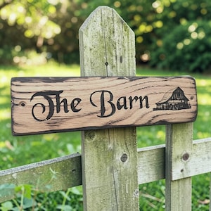 Engraved barn style oak house sign mounted on garden fence