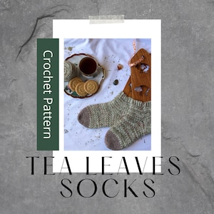 May include: Crochet pattern for tea leaves socks. The pattern includes instructions for crocheting a pair of socks with a speckled green and brown yarn. The image shows the finished socks, a cup of tea, and a plate of cookies.