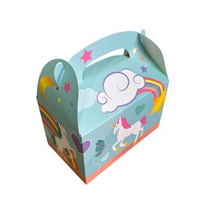 May include: A blue and pink unicorn-themed party favor box with a handle. The box features a unicorn, a rainbow, a cloud, and stars.