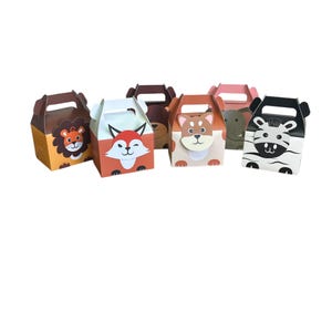 May include: Six small cardboard boxes with animal faces on the front. The boxes are brown, orange, white, and gray. The animals are a lion, fox, bear, dog, elephant, and zebra.