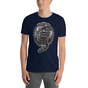 May include: A navy blue t-shirt with a black and white illustration of a cat sitting in a circle with the text "Night Cattitude" around it.