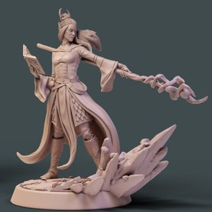 May include: A detailed miniature figurine of a female elf wizard casting a spell. She is wearing a long robe and holding a staff with a swirling design. The base of the figurine is made of a rocky material with crystals.