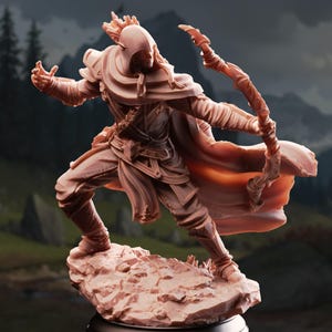 May include: A detailed, monochromatic figurine of an archer in a dynamic pose, drawing a bow. The figure is clad in armor and a hooded cloak, standing on a rocky base. The background features a blurred landscape with trees and mountains.