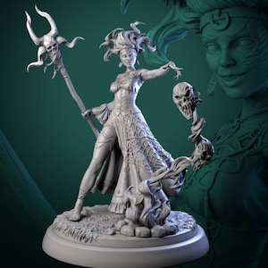 May include: A gray painted miniature figurine of a female sorceress with long flowing hair, wearing a long dress and holding a staff with a skull at the top. The sorceress is standing on a round base with a skull and flames at her feet.