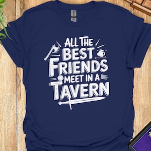 May include: A navy blue t-shirt with a white graphic that says "All the best friends meet in a tavern". The graphic includes a sword, a dice, a mug, and an axe.