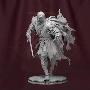 May include: A gray, detailed figurine of a hooded figure holding a sword. The figure is wearing armor and a flowing cloak. The figurine is standing on a circular base.