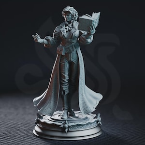 May include: A gray resin miniature figurine of a standing figure wearing a long, textured coat with puffed sleeves, a cravat, and trousers. The figure holds an open book in one hand and stands on a circular, ornate base with star-like details.