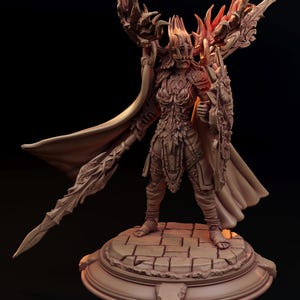 May include: A detailed figurine of a warrior in ornate armor, holding a sword and shield. The figure has a flowing cape and is standing on a circular base. The armor and weapons have intricate designs, and the color is a muted brown.