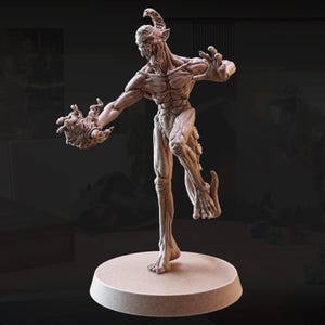 May include: A detailed, beige-colored figurine of a demonic creature with horns, outstretched arms, and a menacing expression. The figure is posed on a circular base, showcasing intricate musculature and a grotesque aesthetic.