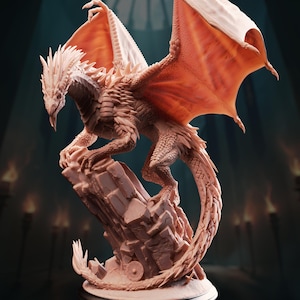 May include: A detailed sculpture of a dragon with outstretched wings, perched atop a rocky formation. The dragon is primarily a light beige color with orange-red wings. The sculpture has intricate details, including scales, claws, and a spiked spine. The dragon's tail curls around the base.
