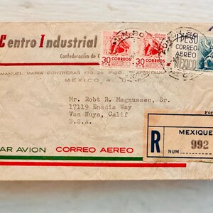 May include: A vintage envelope with a red, white, and green border. The envelope is addressed to Mr. Robt B. Magnussen, Sr. 17119 Enadia Way Van Nuys, Calif U.S.A. The envelope has a stamp with the text "30 CORREOS" and "MEXICO". The envelope also has a stamp with the text "PESO CORREO AEREO MEXICO". The envelope has a red and green stripe across the bottom with the text "PAR AVION CORREO AEREO". The envelope has a red and green stripe across the top with the text "Centro Industrial Confederación de C".